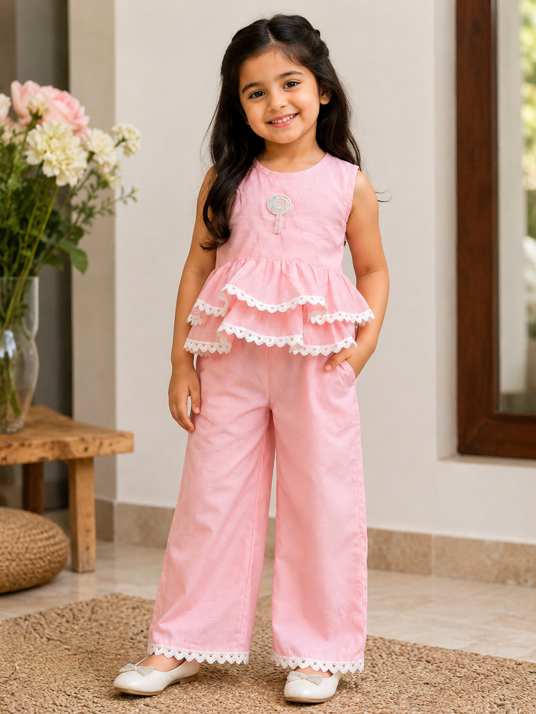 Beautiful girl wearing soft pink layered frill co-ord set with wide leg pants