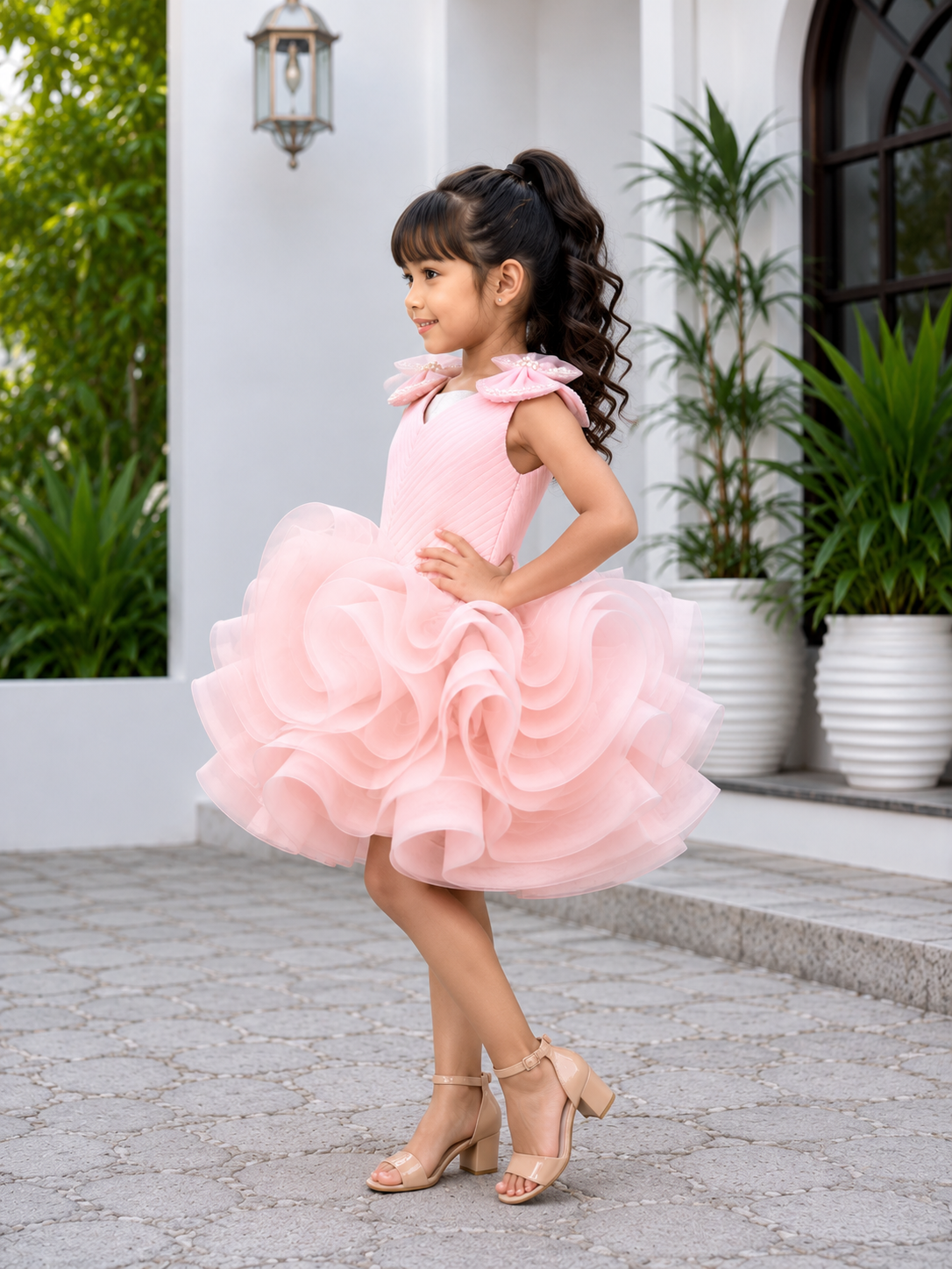 Blush pink couture party dress for girls with pearl embellished shoulder bows and dramatic layered ruffle skirt 1