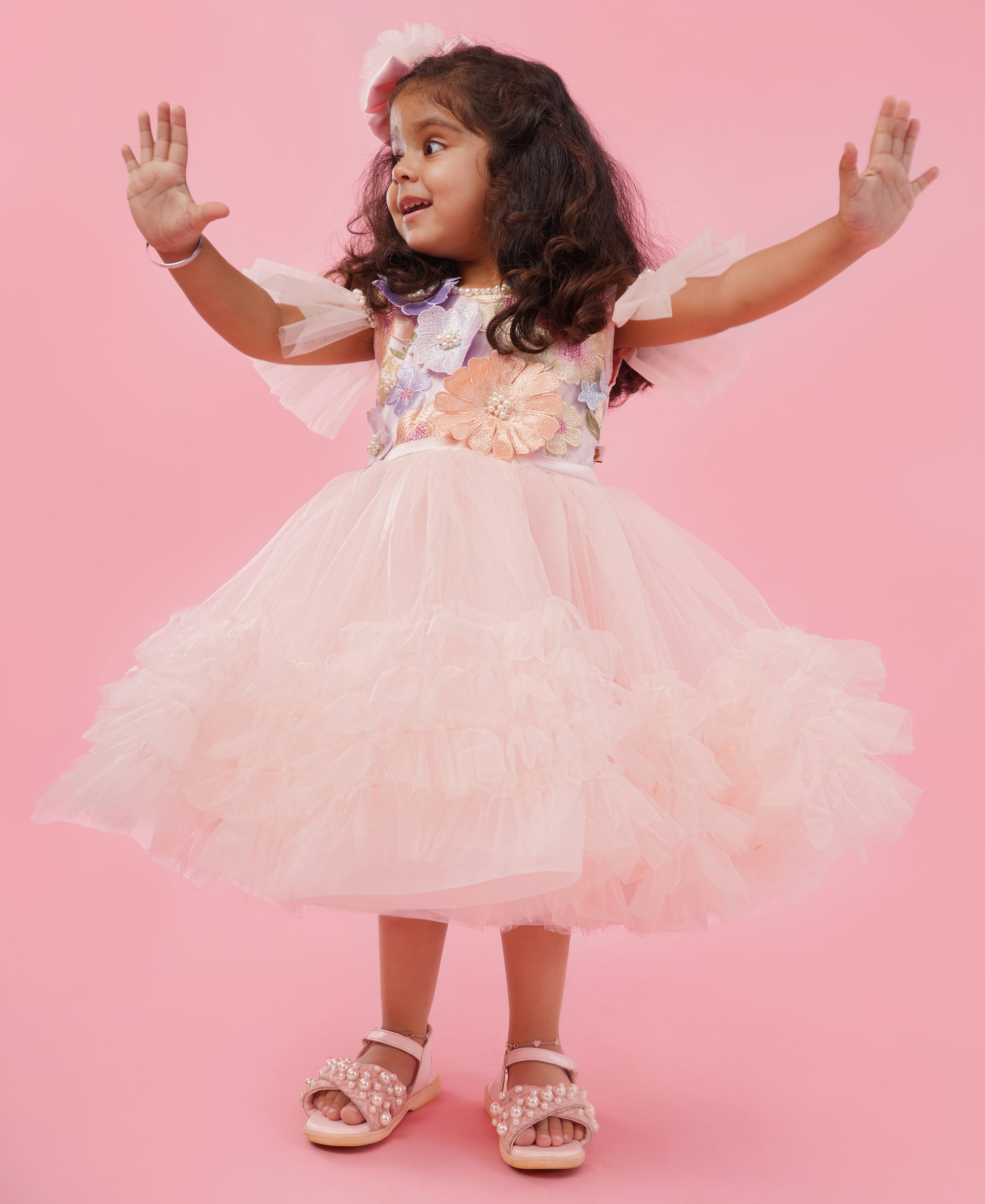 Blush pink floral couture high-low party gown for girls with embellished floral bodice and layered ruffle train 1