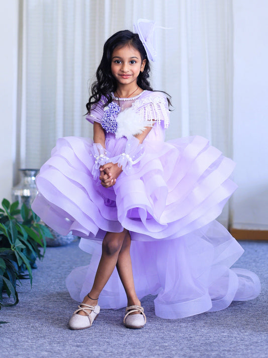 Lavender layered couture dress for girls with structured shoulders, pearl embellishments and dramatic ruffle flare