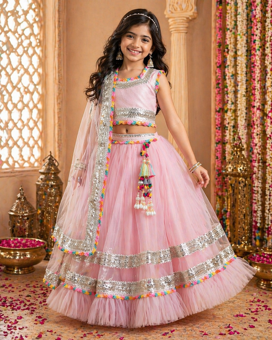 Little girl wearing Pear Bear blush pink celebration lehenga set with premium imported fabric blouse, soft net skirt, silver detailing, and festive ethnic styling.