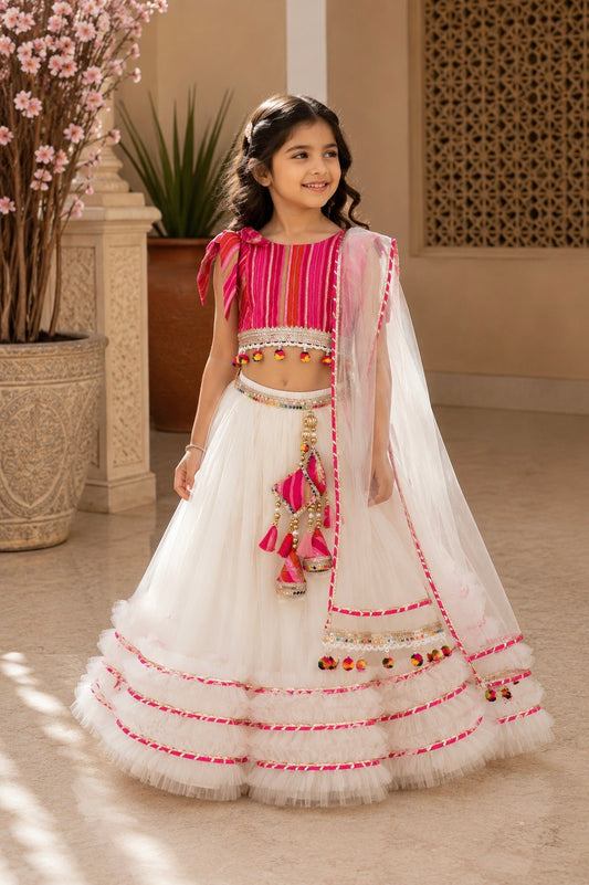 Pear Bear girl wearing white layered lehenga with pink striped blouse and net dupatta in festive ethnic style
