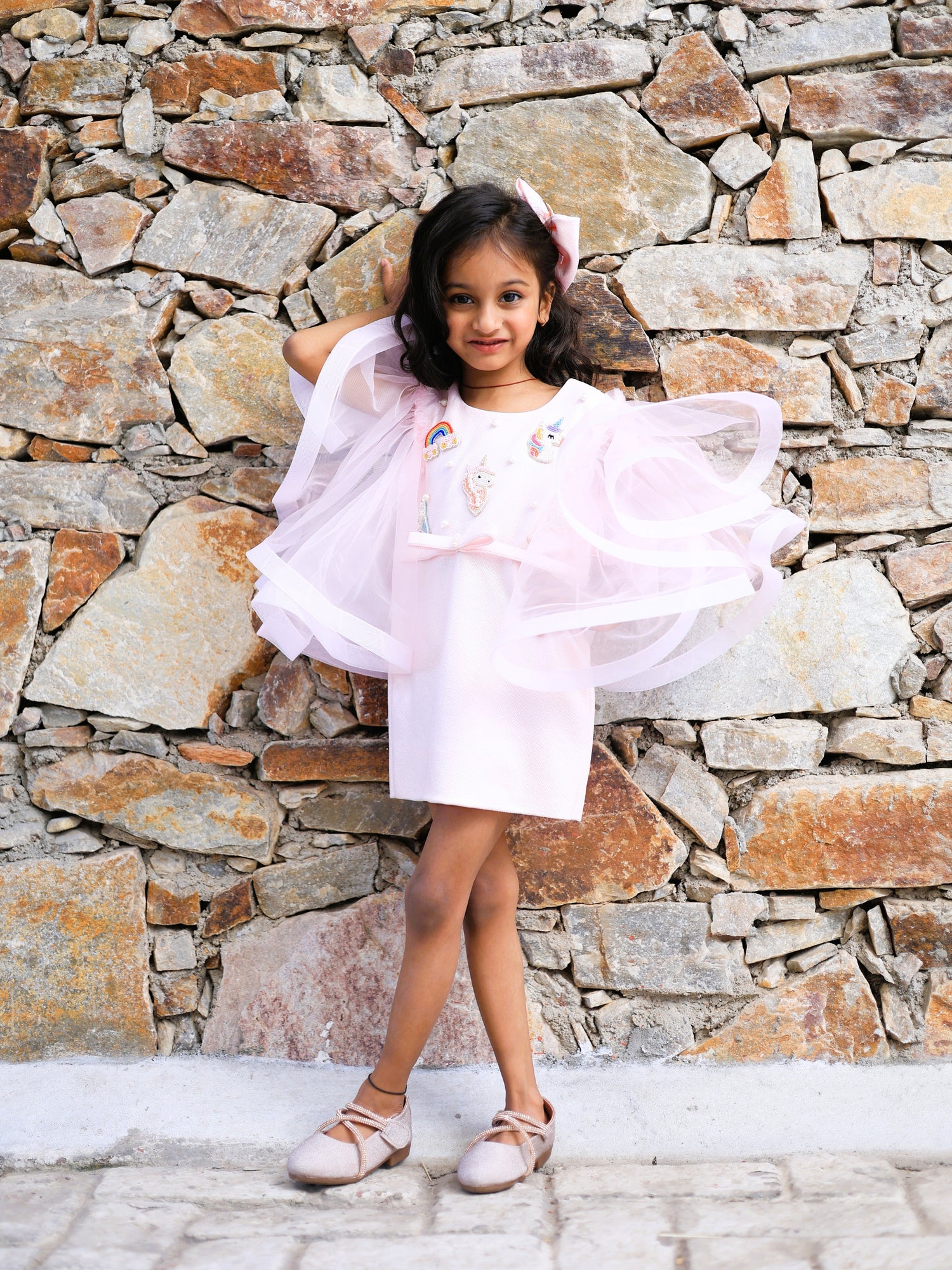 
Pink unicorn embroidered party dress for girls with dramatic flared sleeves and rainbow detailing