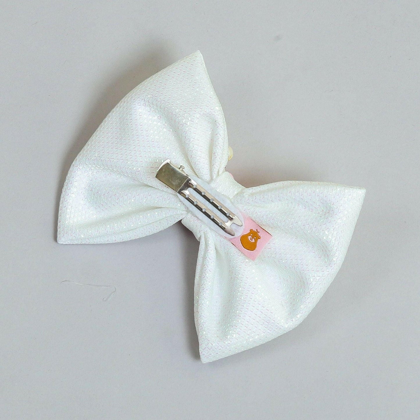 Pear Bear Shimmery flower and pearl adorned bow.