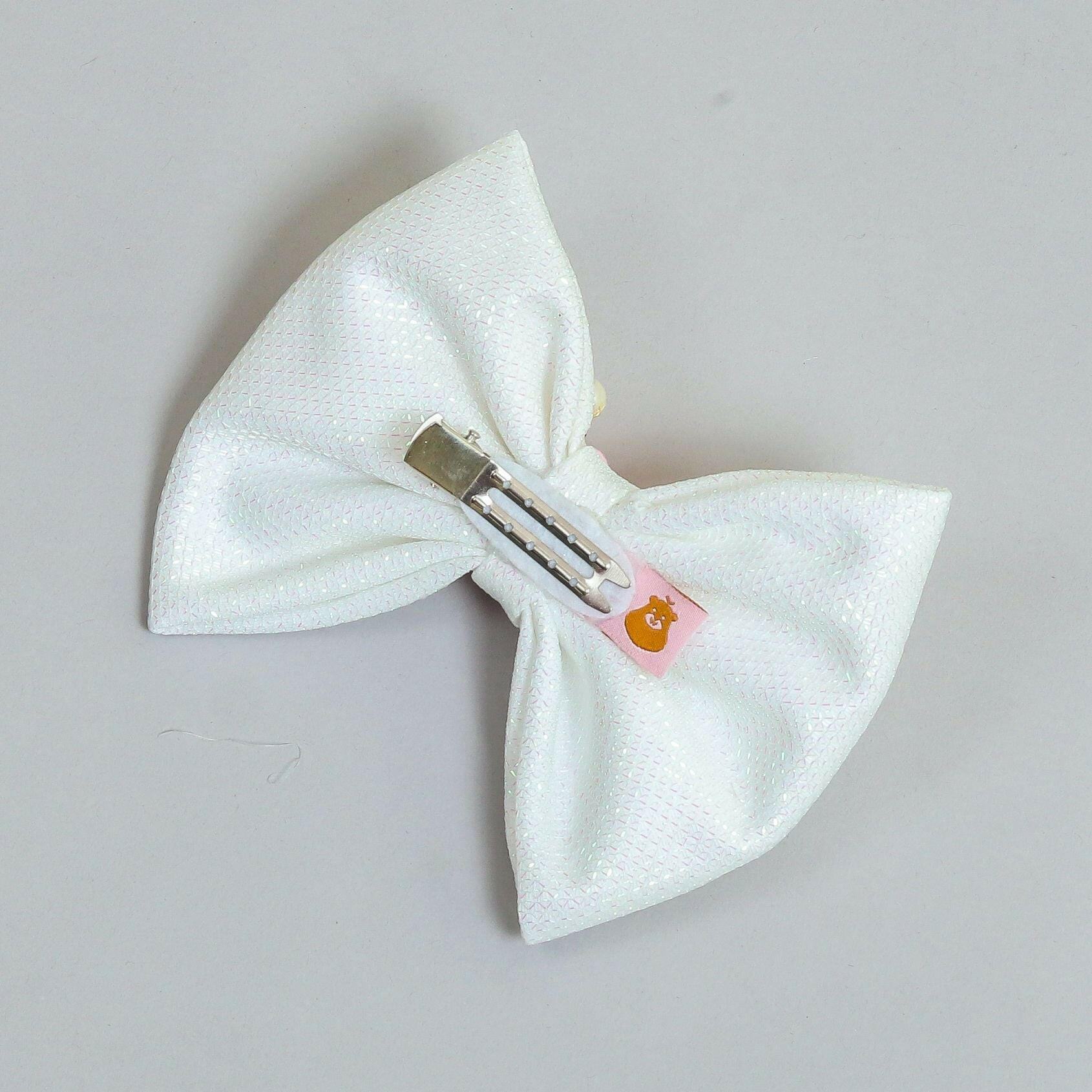 Pear Bear Shimmery flower and pearl adorned bow.