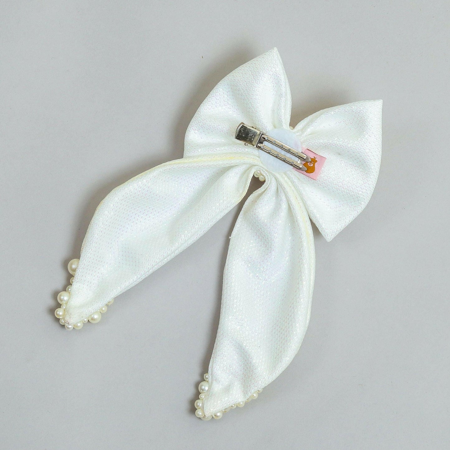 Pear Bear Shimmery pearl adorned beautiful pigtail bow.